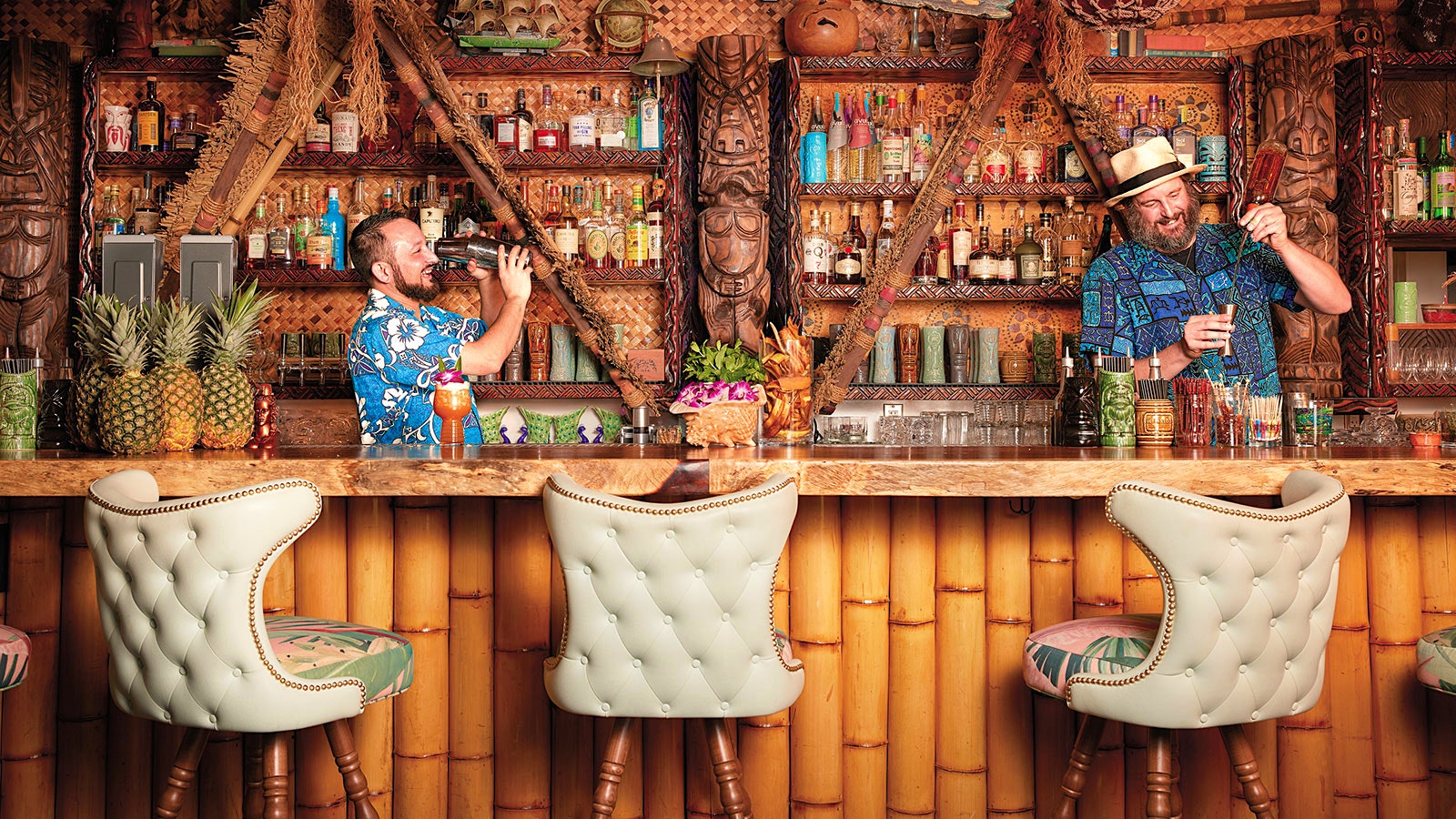 Two bartenders prepare drinks at Wilfred’s Lounge.